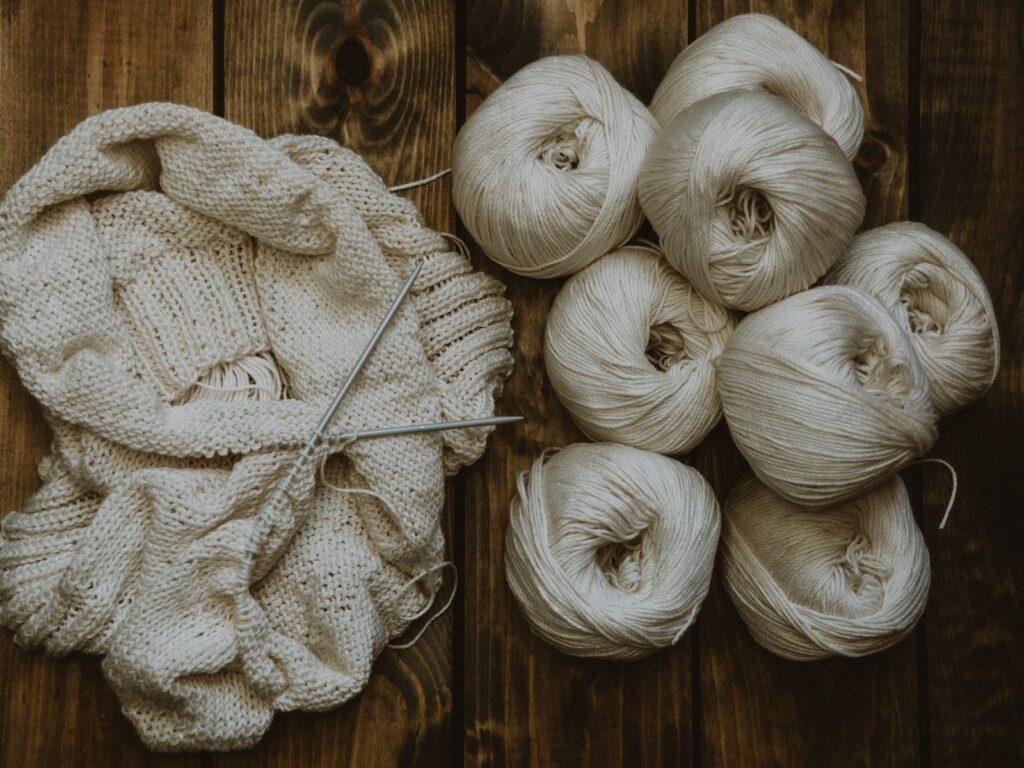 white yarn on brown wooden table